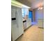 Bright kitchen featuring tile floor, stainless steel dishwasher, lots of white cabinets and sliding glass door at 1561 Cypress Woods Cir, St Cloud, FL 34772