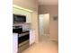 Modern kitchen with stainless steel appliances, granite countertops, and white cabinets, blending style and functionality at 1561 Cypress Woods Cir, St Cloud, FL 34772