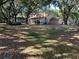 Large backyard featuring mature trees, a sunroom, and a detached shed at 1835 Harbor Blvd, Kissimmee, FL 34744