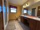 Bathroom featuring a double sink vanity with a shower and carpeted floors at 1835 Harbor Blvd, Kissimmee, FL 34744