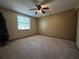 Bedroom featuring neutral walls with a ceiling fan, and one window with carpeted floors at 1835 Harbor Blvd, Kissimmee, FL 34744