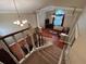 View from the top of the stairs looking down to the dining room with vaulted ceiling and hardwood floors at 1835 Harbor Blvd, Kissimmee, FL 34744