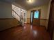 Inviting entryway featuring hardwood floors, a wooden door with decorative glass, and a staircase with a chairlift at 1835 Harbor Blvd, Kissimmee, FL 34744