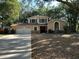 Charming two-story home with a well-manicured lawn, mature trees, and an attached two-car garage at 1835 Harbor Blvd, Kissimmee, FL 34744