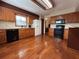 Spacious kitchen with wood cabinets, black appliances, and hardwood floors at 1835 Harbor Blvd, Kissimmee, FL 34744