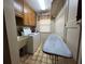 Functional laundry room featuring a washer, dryer, utility sink, and ironing board at 1835 Harbor Blvd, Kissimmee, FL 34744