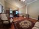 Open-concept living room and dining area with hardwood floors, high ceilings, and staircase to the second floor at 1835 Harbor Blvd, Kissimmee, FL 34744