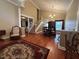 Open-concept living room and dining area with high ceilings, hardwood floors, and a staircase to the second floor at 1835 Harbor Blvd, Kissimmee, FL 34744
