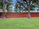 The landscaped backyard features a brick wall for privacy, offering a serene outdoor retreat at 1933 Estancia Cir, Kissimmee, FL 34741