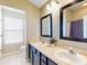 This bathroom features double sinks, neutral countertops, and a separate shower/tub area for convenience at 1933 Estancia Cir, Kissimmee, FL 34741