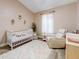Beautiful Bedroom complete with crib, rug, chair, and soft lighting at 1933 Estancia Cir, Kissimmee, FL 34741