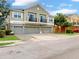 Well-maintained townhome features multiple car garages and attractive landscaping at 1933 Estancia Cir, Kissimmee, FL 34741