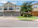 Charming townhome with a two-car garage, landscaped yard, and beautiful tree providing shade at 1933 Estancia Cir, Kissimmee, FL 34741