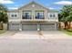 Charming townhome with multiple car garages and quaint balconies, enhancing curb appeal at 1933 Estancia Cir, Kissimmee, FL 34741