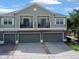 This two-story home has a three-car garage and a covered entryway, offering ample parking and curb appeal at 1933 Estancia Cir, Kissimmee, FL 34741
