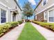 Inviting walkway lined with lush greenery leading to the front of the home at 1933 Estancia Cir, Kissimmee, FL 34741