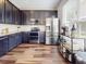 Modern kitchen with stainless steel appliances, sleek cabinets, and hardwood flooring at 1933 Estancia Cir, Kissimmee, FL 34741