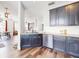 Stylish kitchen featuring stainless steel appliances, dark cabinets, and hardwood flooring at 1933 Estancia Cir, Kissimmee, FL 34741