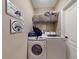 Functional laundry room featuring modern washer and dryer with storage at 1933 Estancia Cir, Kissimmee, FL 34741