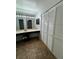 The bathroom features a long vanity with a sink, a large mirror, and a closet with shuttered doors at 200 Maitland Ave # 80, Altamonte Springs, FL 32701
