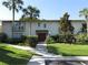 Inviting condo featuring a lush green lawn, mature trees, and a pathway to the front door at 200 Maitland Ave # 80, Altamonte Springs, FL 32701