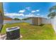 View of the backyard with shed, AC unit, and fenced perimeter at 2040 Patriot Way, St Cloud, FL 34769