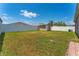Spacious fenced backyard with a shed and lush green grass, perfect for outdoor activities at 2040 Patriot Way, St Cloud, FL 34769