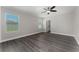 Open bedroom with two windows, ceiling fan, wood floors and modern fixtures at 2040 Patriot Way, St Cloud, FL 34769