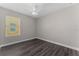 Clean bedroom with a window and modern ceiling fan, wood-look flooring at 2040 Patriot Way, St Cloud, FL 34769