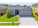 Exterior shot of a single Gathering home showing the garage and landscaped front yard at 2040 Patriot Way, St Cloud, FL 34769