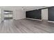 Open concept living room with sliding doors leading to the patio, and stylish geometric accent wall at 2040 Patriot Way, St Cloud, FL 34769