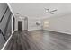 Spacious living room featuring hardwood floors, a ceiling fan, and an open view into the kitchen at 2040 Patriot Way, St Cloud, FL 34769
