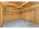 Shed interior displaying the overhead wood framing, wall paneling, and mounted shelving at 2040 Patriot Way, St Cloud, FL 34769