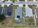 Aerial view of the home, showcasing the backyard pool, screened in porch and surrounding properties at 2206 Hunters Greene Dr, Lakeland, FL 33810