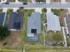 Aerial view of a house featuring a screened pool and lush green backyard at 2206 Hunters Greene Dr, Lakeland, FL 33810