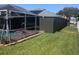 A green lawn adjoins the screened-in pool deck at 2206 Hunters Greene Dr, Lakeland, FL 33810