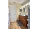 Bathroom with a vanity, framed mirror, wood-look tile flooring, and adjacent toilet at 2206 Hunters Greene Dr, Lakeland, FL 33810