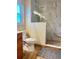Well-appointed bathroom featuring a glass shower, toilet, and wood-look tile flooring at 2206 Hunters Greene Dr, Lakeland, FL 33810
