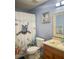 Cozy bathroom features a unique shower curtain and a well-lit vanity with ample storage at 2206 Hunters Greene Dr, Lakeland, FL 33810