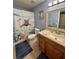 Bright bathroom featuring a quirky cat-themed shower curtain and a wooden framed mirror at 2206 Hunters Greene Dr, Lakeland, FL 33810