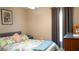 Bedroom featuring a floral bedspread, neutral walls, and dark drapes at 2206 Hunters Greene Dr, Lakeland, FL 33810
