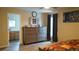 A calming bedroom features a large dresser and an attached bathroom for convenience at 2206 Hunters Greene Dr, Lakeland, FL 33810