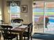 Cozy dining room with classic wood table and view of the inviting pool area at 2206 Hunters Greene Dr, Lakeland, FL 33810