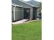 Inviting home entrance featuring a security gate, lush mulch, and decorative outdoor figurines at 2206 Hunters Greene Dr, Lakeland, FL 33810