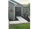 Charming front entrance with a secure gate, decorative plants, and a unique personalized 'Woodard' welcome sign at 2206 Hunters Greene Dr, Lakeland, FL 33810