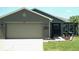 Charming single-story home features a neutral color scheme, two car garage and manicured lawn at 2206 Hunters Greene Dr, Lakeland, FL 33810