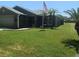 Well-maintained single-story home with lush green lawn and palm trees offers curb appeal at 2206 Hunters Greene Dr, Lakeland, FL 33810