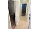 Hallway leading to a bedroom and bathroom with tile floors and neutral walls at 2206 Hunters Greene Dr, Lakeland, FL 33810