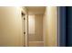 Hallway with tile floors and white walls, featuring a storage closet and door frames at 2206 Hunters Greene Dr, Lakeland, FL 33810