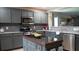 Well-designed kitchen featuring stainless appliances, dark cabinetry, and tiled backsplash at 2206 Hunters Greene Dr, Lakeland, FL 33810